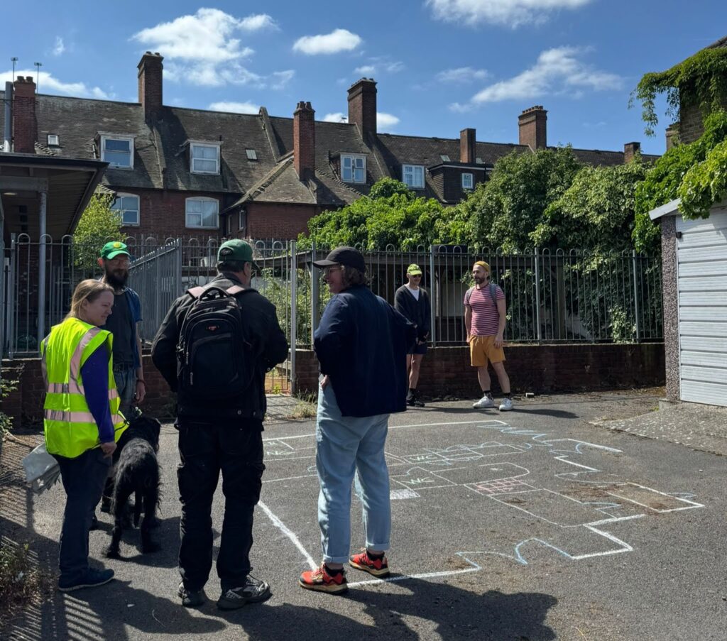 Residents in the yard looking at the floorplan